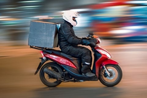 A delivery agent on a bike