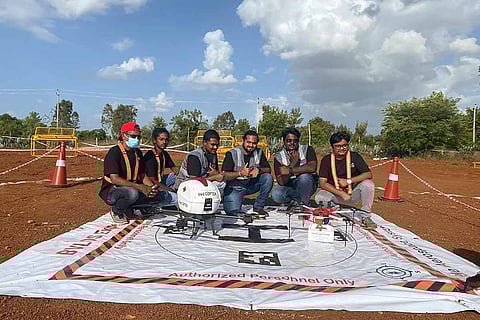 The TAS team posing with the drone