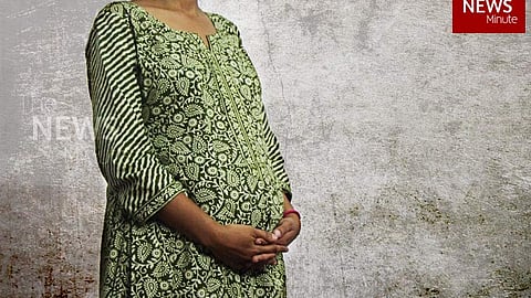 Image of a pregnant woman with focus on her belly