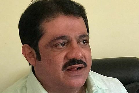 Zameer Ahmed Khan wearing green shirt