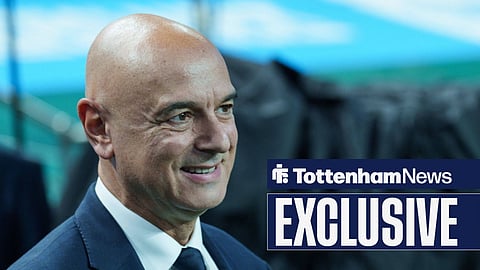 Daniel Levy smiling while wearing a suit