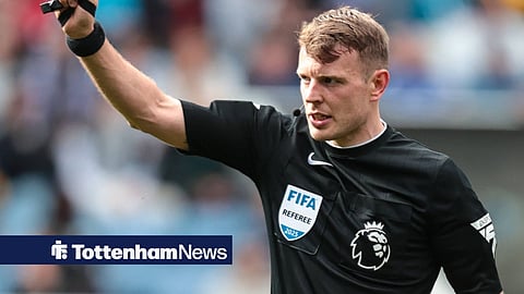 Premier League referee Samuel Barrott brandishing a card
