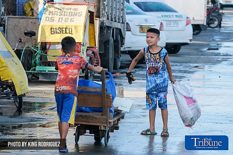 Children on the streets play as they sift through junk and dream of the future