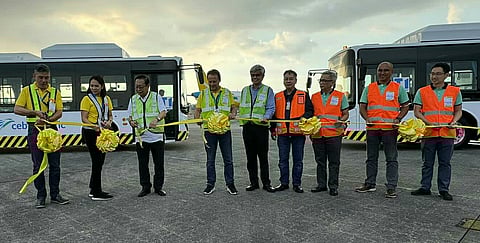 Cebu Pacific, MIAA, DOTr, and Therma One Transport officials attend the ribbon-cutting ceremony for CEB’s two new electric shuttle buses. From L to R: Alvin Candelaria, MIAA OIC for Airport Ground Operations and Safety Division; Alex Reyes, CEB Chief Strategy Officer; Lei Apostol, CEB Vice President-Customer Service Operations; Eric Jose Ines, MIAA General Manager; Javier Massot, CEB Chief Operations Officer; Junard J. Cruz, Consultant to the DOTr Undersecretary for Aviation & Airports; Larry Francisco, NAIA-T3 Terminal Manager; Anthony Fernandez, Therma One President and Chief Operating Officer; Jose Valentin A. Pantangco Jr., Therma One Deputy Chief Operating Officer; and Humprey T. Levi Dy, Therma One Rentals and Transport General Manager. (Photo by Anthony Ching)