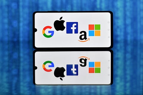 (FILES) An illustration picture taken in London on 18 December 2020 shows the logos of Google, Apple, Facebook, Amazon, and Microsoft displayed on a mobile phone.


