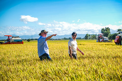 President Ferdinand Romualdez Marcos Jr. is welcomed by Agriculture Secretary Francisco Tiu Laurel Jr. during a ceremonial harvesting event and assistance distribution in Brgy. Mandili, Candaba, Pampanga on 3 February 2024. 