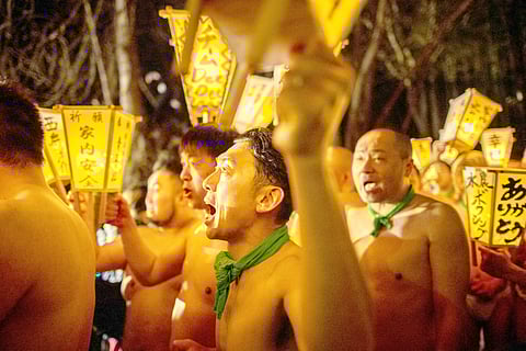 MEN carry lanterns as they walk to a river to cleanse their bodies during the Sominsai Festival at Kokuseki-ji Temple in Oshu, Iwate Prefecture, Japan on 17 February 2024.