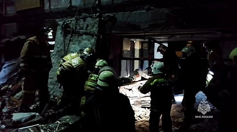This grab from handout footage released by the Russian Emergencies Ministry on February 3, 2024 shows rescuers clearing rubble, taking out victims' bodies and searching for survivors inside a destroyed bakery hit by recent shelling in the city of Lysychansk.