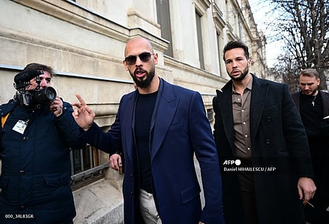 (FILE PHOTO) Andrew Tate (L) and Tristan Tate (R) walk from the Bucharest's Court of Appeal after a hearing about their demand to be allowed to leave Romania as their mother allegedly suffered a heart attack, in Bucharest, on 22 December  2023. Controversial influencer Andrew Tate and his brother have been arrested in Romania over UK sex offence charges, police said on 12 March 2024. Police said in a statement it executed "two European arrest warrants issued by the UK judicial authorities for the committing of sexual offenses, of exploitation of persons on the territory of the UK".


