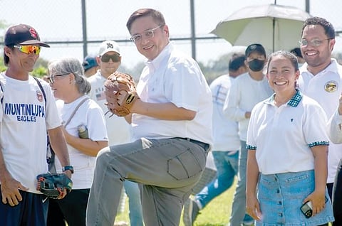 Muntinlupa Mayor Rufino ‘Ruffy’ Biazon makes the ceremonial pitch during the inauguration of the city’s own baseball field in Barangay Tunasan yesterday.