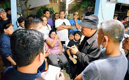 TRAGIC. Antipas Mayor Cristobal Cadungon (right, in black hat) visits a funeral parlor at the Cotabato town on Monday night (March 25, 2024) to meet with the families of the victims of a road accident that killed 17. All but one of the passengers of a van died after it collided with a dump truck earlier in the day.