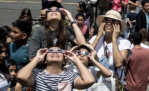 (FILES) People watch the annular eclipse of the sun at the planetarium of the University of Costa Rica (UCR) in San Jose, on 14 October 2023. Skygazers across the Americas turned their faces upwards Saturday for a rare celestial event: an annular solar eclipse.