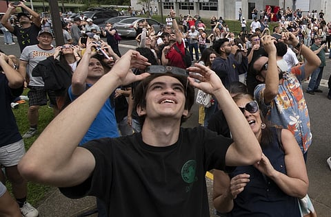 (FILES) People observe the annular eclipse of the sun at the planetarium of the University of Costa Rica (UCR) in San Jose, on 14 October 2023. Skygazers across the Americas turned their faces upwards Saturday for a rare celestial event: an annular solar eclipse.
