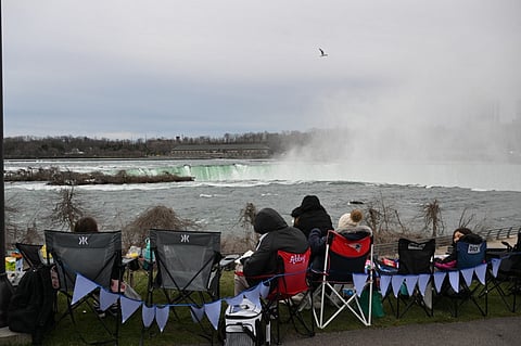 People are set up at Niagara Falls State Park ahead of a total solar eclipse across North America, in Niagara Falls, New York, on April 8, 2024. This year's path of totality is 115 miles (185 kilometers) wide and home to nearly 32 million Americans, with an additional 150 million living less than 200 miles from the strip. The next total solar eclipse that can be seen from a large part of North America won't come around until 2044.

