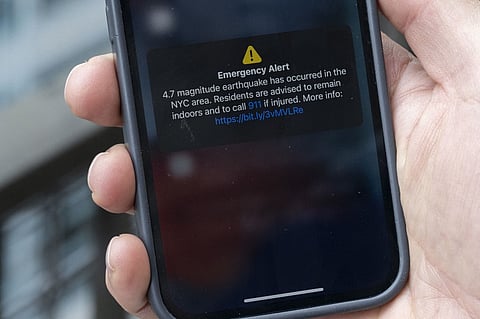 In this illustration, a phone shows an Emergency Alert message on 5 April 2024, warning of an earthquake in New York. New York City was shaken by a small earthquake on Friday with a 4.8 magnitude and an epicenter in neighboring New Jersey, according to the US Geological Survey (USGS). There were no initial reports of injuries or damage. In Brooklyn buildings shook, rattling cupboard doors and fixtures, an AFP correspondent reported.