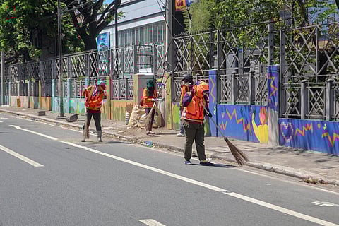 Amid the scorching Monday heat, street sweepers continue to do their job along Pasay Road but not without protective gear such as long-sleeved vests, caps and face covering.
