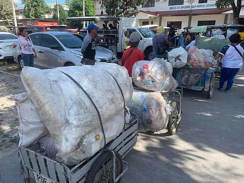 
PLASTIC bottle collectors troop to the Walang Plastikan redemption booth in Angeles City Hall.