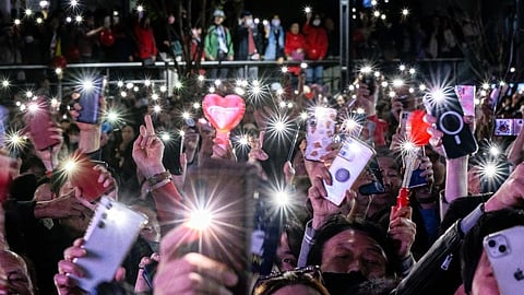 Supporters raise their phone torches during a campaign rally for South Korea's ruling People Power Party (PPP), on the eve of the parliamentary elections in Seoul on 9 April 2024.
