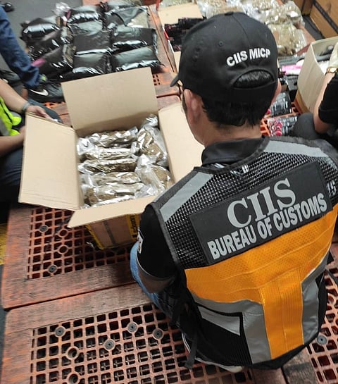 Personnel from the Bureau of Customs Intelligence and Investigation Service inspect suspected kush and smuggled vapes with cannabis content on Wednesday at the Manila International Container Port. 