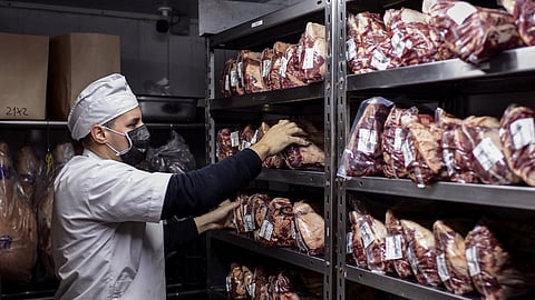 (FILES) A butcher works at the butcher's shop of the Don Julio restaurant in Palermo neighborhood, Buenos Aires, on 20 May 2021.
