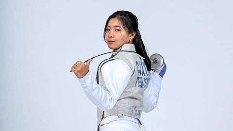 Woman in fencing attire