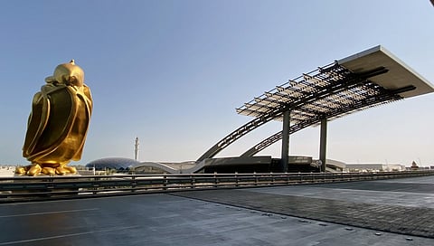 (FILES) Falcon, a giant gold finished sculpture by Dutch artist Tom Claassen of the hunting bird popular in the Gulf region, is pictured at Doha's Hamad International Airport on 19 July 2021.
