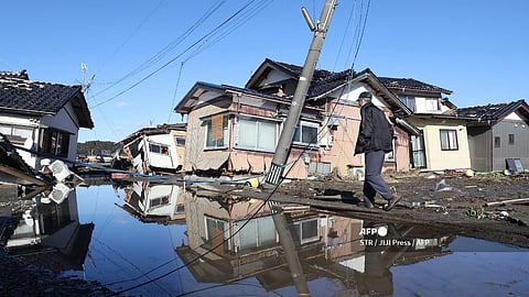 (FILES) A man walks down a street in an area of the disaster-hit city of Suzu, Ishikawa prefecture on 11 January 2024 after a major 7.5 magnitude earthquake struck the Noto region in Ishikawa prefecture on New Year's Day. 