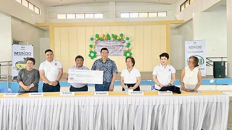 MORE Power Inc. president Roel Castro (3rd from left) hands a symbolic check worth P704,000 to former Senate president Franklin Drilon. With them are (from left) San Miguel municipal health office head Dr. Mary Jane Gimeno, Iloilo provincial health officer Dr. Wendel Marcelo, San Miguel Mayor Marina Luz Gorriceta and Iloilo provincial health officer II Dr. Maria Socorro Quiñon. 
