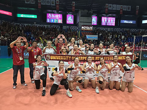 Players and coaches of University of Perpetual Help System Dalta celebrate after beating Arellano University in five sets to capture the Season 99 NCAA girls’ volleyball title.