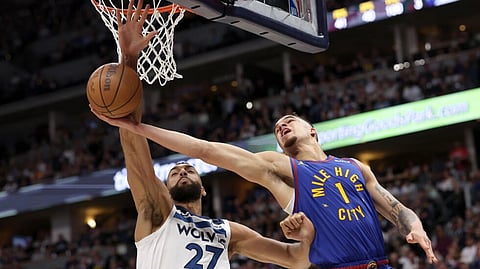 Minnesota's Rudy Gobert (left) blocks Denver's Michael Porter Jr; Gobert has been named NBA's Defensive Player of the Year for the fourth time