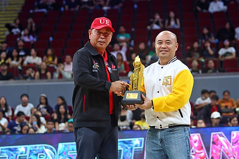 UST Institute of Physical Education and Athletics director Fr. Rodel Cancancio (right) accepts the trophy from UAAP president Zosimo Battad that signifies their dominance in Season 86 of the UAAP.    