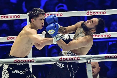 
NAOYA Inoue (left) recovers from an early mishap to knock down Luis Nery in the sixth round of their super-bantamweight world title fight late Monday at the Tokyo Dome in Japan.