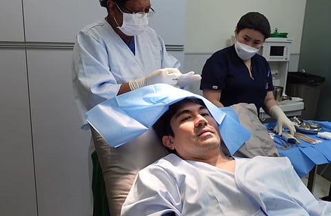 LUIS Manzano undergoes checkup on what is believed to be a lump on his head.