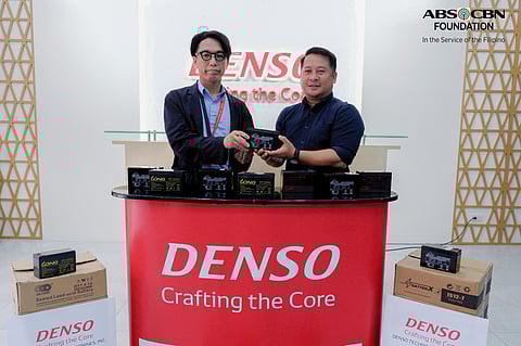 MORIHIRO Takano, DTPI executive vice president (left), hands donated ULABs to Sherwin Hinlo, ABS-CBN Foundation officer-in-charge for Resource Mobilization and Donor Management.