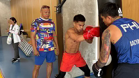 NATIONAL coach Ronald Chavez observes Carlo Paalam as he works out inside the Team Philippines’ training camp at La Moselle in Metz, France.