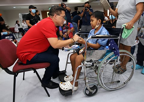 SENATOR Christopher 'Bong' Go takes time to listen to the story of a young patient at the Philippine Children's Medical Center in Quezon City on Wednesday.