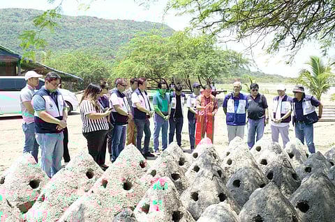 RC Makati officers, with a local priest officiating in the blessing of reef buds before these are dropped in Sulvec, Narvacan, Ilocos Sur. This is part of the Club's Save Our Reefs project in the area. An additional 60 reef buds were cast, bringing the total to 340 reef buds. In the photo are (front row, from left) Rotarian Paolo Turno, two United Philippine Leaf Inc. female employees, RC Makati treasurer Tetu Garcia, UPLI president and RC Makati director, Winston Uy, Narvacan Mayor Pablito Sanidad, a local priest from Narvacan, RC Makati president Bing Matoto, and Rotarians Benjie Tayag, Philip Soliven and Andy Mañalac. 