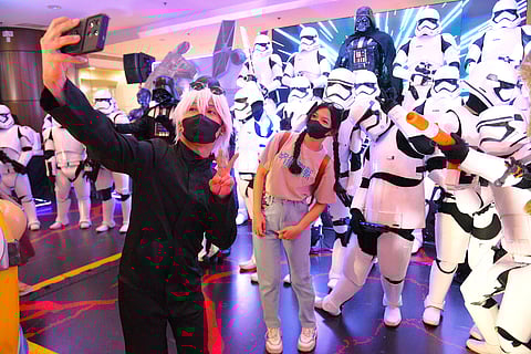 Fans immerse themselves in the excitement as they pose iconic movie characters.