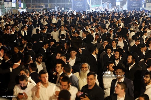 Ultra-Orthodox Jewish men celebrate the Jewish holiday of Lag BaOmer in the Sheikh Jarrah neighbourhood of Israeli-annexed east Jerusalem on May 25, 2024. 
