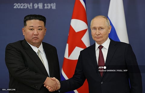 (FILES) This pool image distributed by Sputnik agency shows Russian President Vladimir Putin (R) and North Korea's leader Kim Jong Un (L) shaking hands during their meeting at the Vostochny Cosmodrome in Amur region on September 13, 2023, ahead of planned talks that could lead to a weapons deal with Russian President. 
