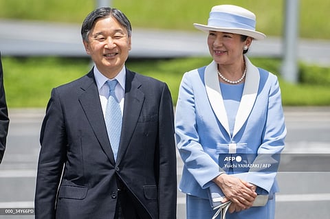 Japan's Emperor Naruhito (L) and Empress Masako (R) arrive at Haneda airport before the Emperor and Empress' departure for Britain, in Tokyo on June 22, 2024.
