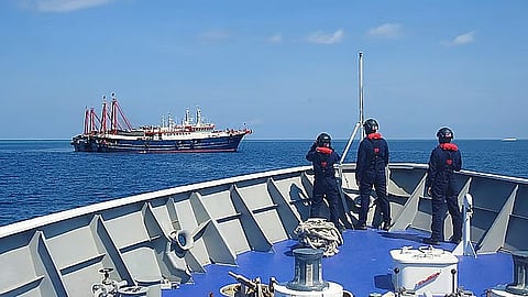 (FILES) Philippine Coast Guard crew members aboard the BRP Cabra monitor a Chinese vessel anchored at Sabina Shoal, a West Philippine Sea outcrop located about 135 kilometers west of Palawan. China’s ‘aggressive’ actions in the WPS have earned condemnation from the Philippines and such countries as the United States, Japan, and Australia. 