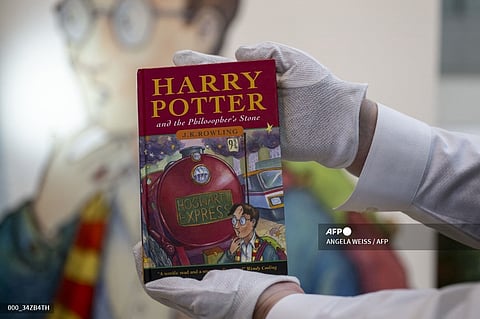 An art handler holds an example of the first hardback issue of the first edition Harry Potter book, one of only 500 copies at Sotheby’s, in New York on June 25, 2024. The item is estimated to be auctioned between $100,000- 150,000 USD during the Fine Books & Manuscripts Auction in June.

