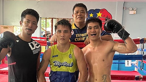 VINCENT Astrolabio (middle) strikes a pose with sparmates Shumpei Kaneshiro (left) and Lienard Sarcon while chief trainer Nonoy Neri looks on during a break in training camp in Davao City.  