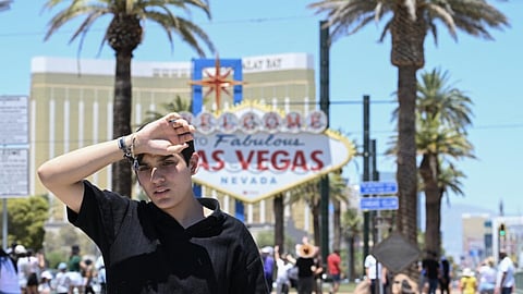 A man walks near the Las Vegas strip during a heatwave in Las Vegas, Nevada, on July 7, 2024