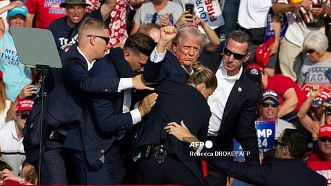 Republican candidate Donald Trump is seen with blood on his face surrounded by secret service agents as he is taken off the stage at a campaign event at Butler Farm Show Inc. in Butler, Pennsylvania, July 13, 2024. Republican candidate Donald Trump was evacuated from the stage at today's rally after what sounded like shots rang out at the event in Pennsylvania, according to AFP.
The former US president was seen with blood on his right ear as he was surrounded by security agents, who hustled him off the stage as he pumped his first to the crowd. Trump was bundled into an SUV and driven away.