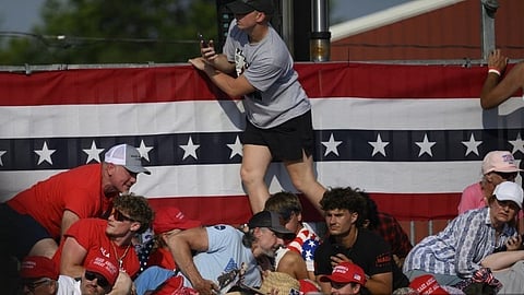 Attendees duck from gunfire at a campaign rally for Republican presidential candidate, former U.S. President Donald Trump at Butler Farm Show Inc. on 13 July 2024 in Butler, Pennsylvania. 