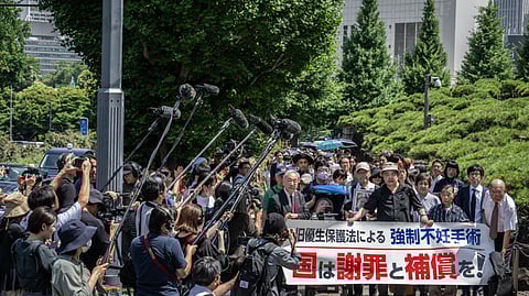 Lawyers and supporters of people forcibly sterilised under a now-defunct eugenics law march toward Japan's Supreme Court in Tokyo