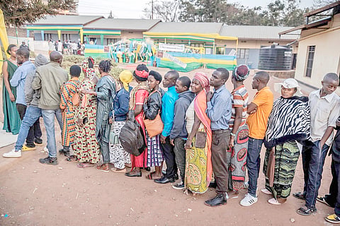 Voters queue to cast their ballot early in the morning before the opening of the polls during the 2024 Rwandan general elections at a polling station in Kigali. Millions of Rwandans head to the polls with veteran President Paul Kagame set to cruise to an easy victory over his two approved challengers and extend his iron-fisted rule for another five years.