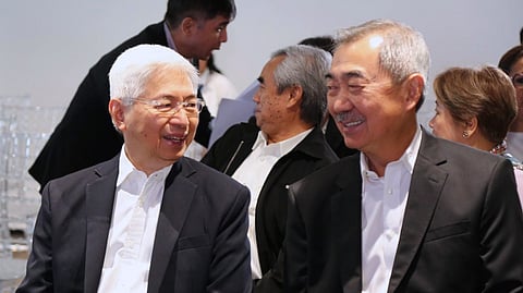 Trade Secretary Alfredo Pascual (left) and SM Prime Holdings Inc. chairman of the Executive Committee Hans Sy are having a cheerful conversation after the signing of a memorandum of understanding on business continuity planning and a memorandum of agreement on the One Town One Product promotion on Monday. 